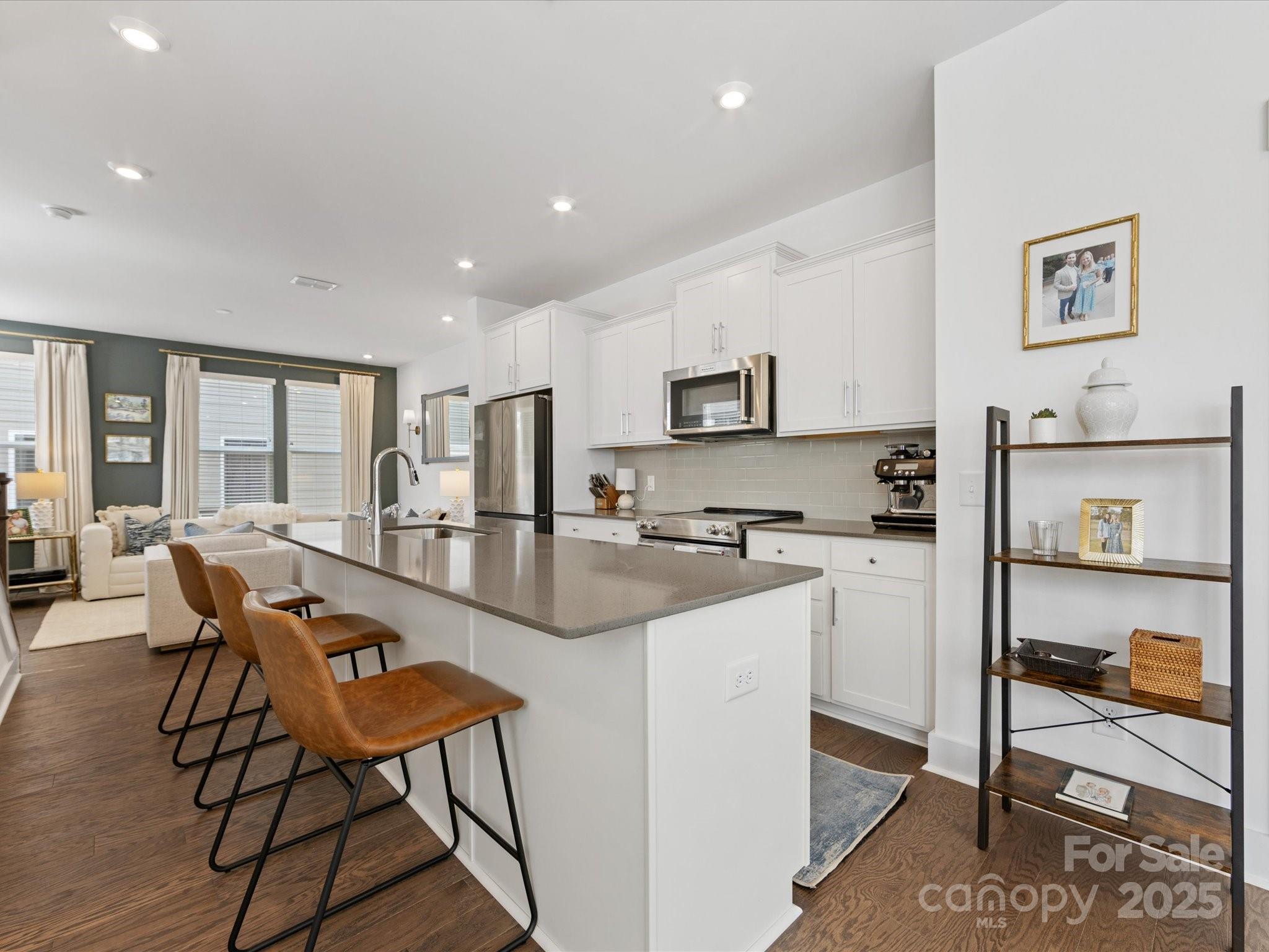 4027 Capital Ridge, Unit 10 Charlotte, NC 28205 - Photo 5 of 34 a open kitchen with white cabinets and stainless steel appliances