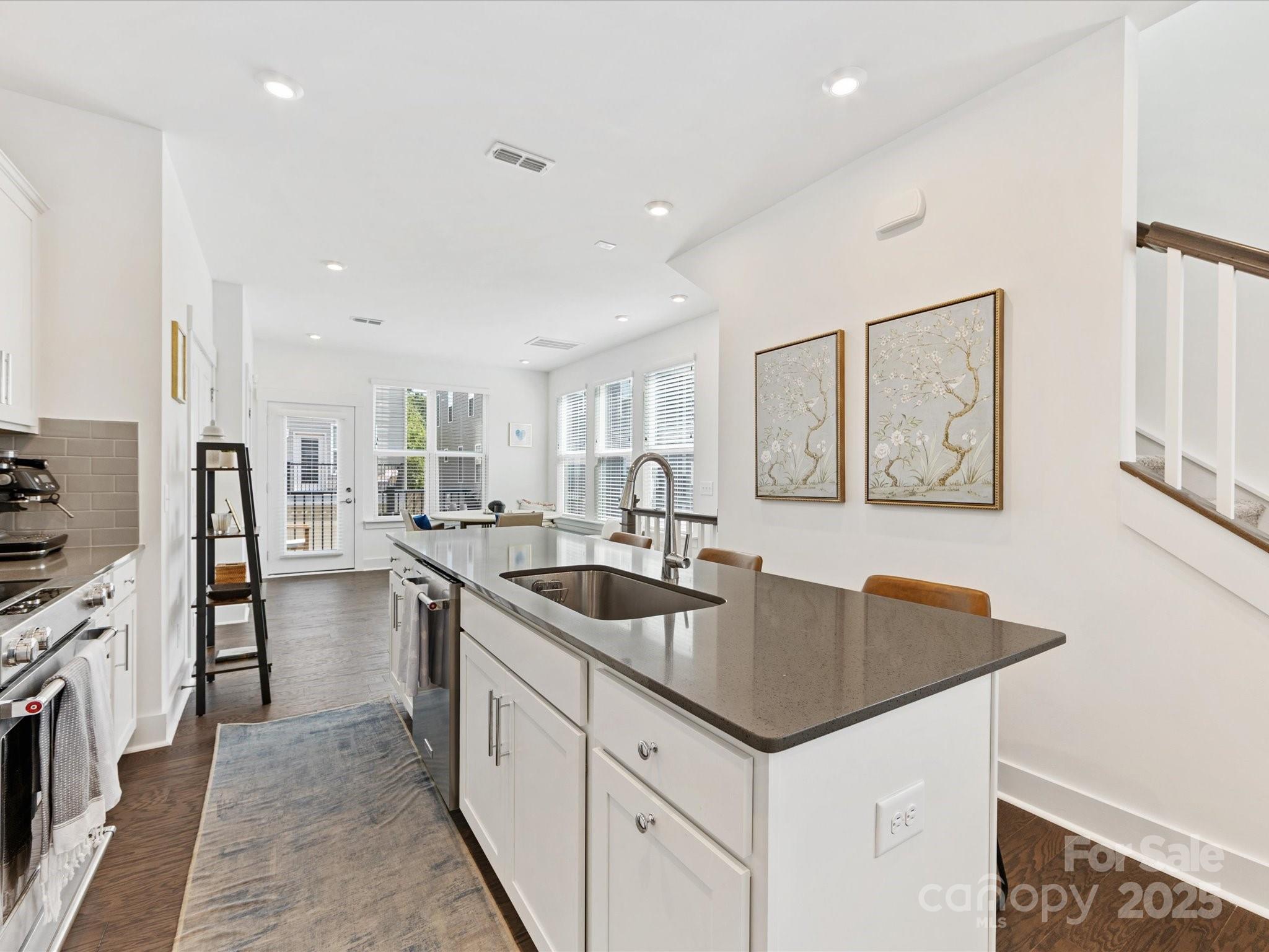 4027 Capital Ridge, Unit 10 Charlotte, NC 28205 - Photo 9 of 34 a kitchen with sink a refrigerator and chairs