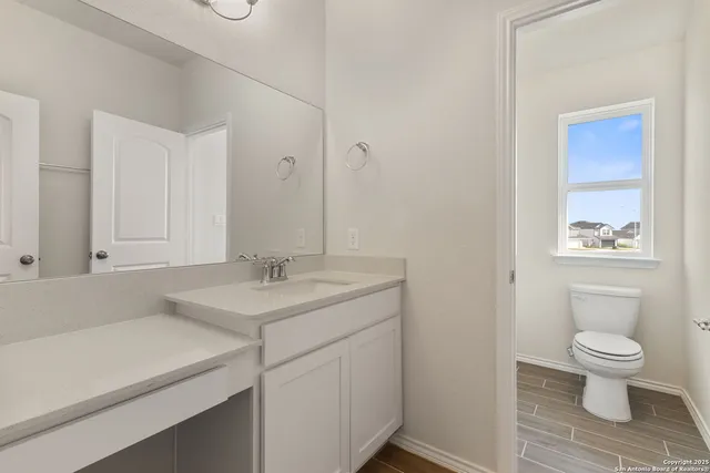 a bathroom with a sink toilet and a mirror