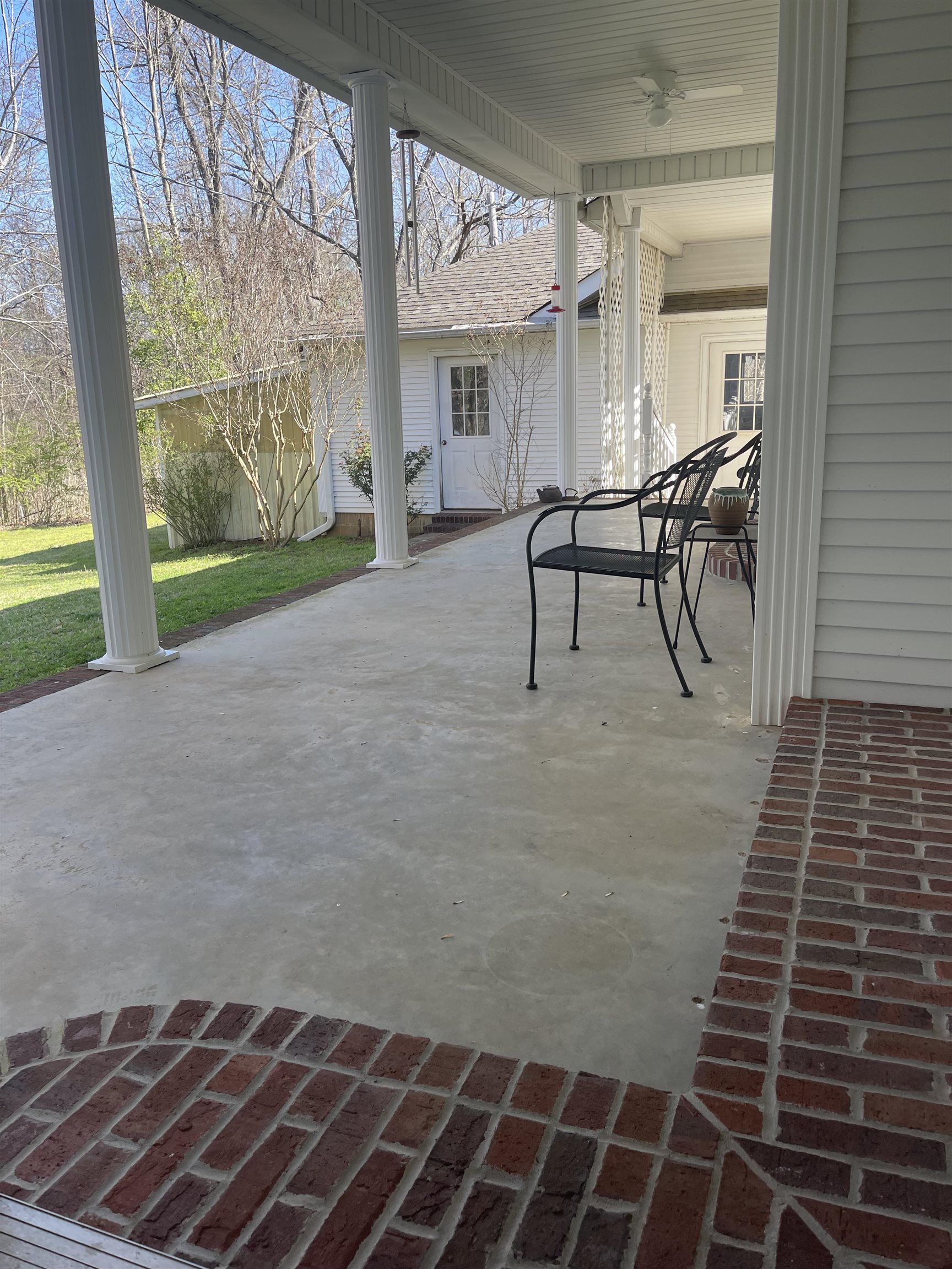 305 New Hope Road Ramer, TN 38367 - Photo 18 of 25 a view of a patio with table and chairs with wooden floor and fence