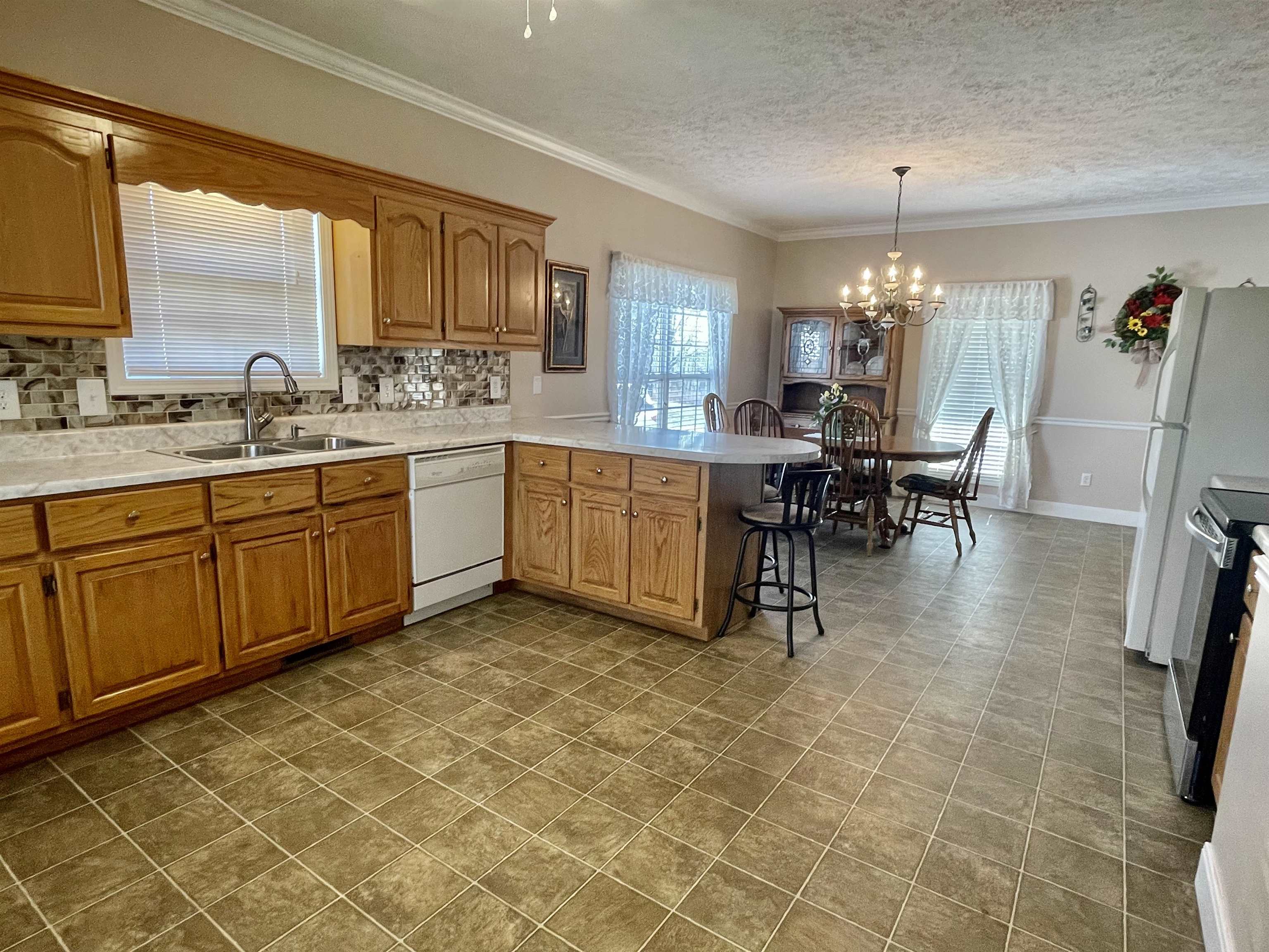 305 New Hope Road Ramer, TN 38367 - Photo 8 of 25 a large kitchen with a table and chairs