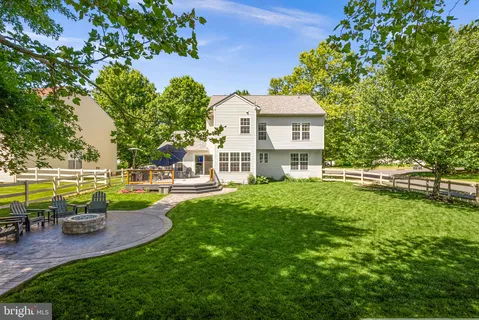 a view of a house with a yard patio and swimming pool