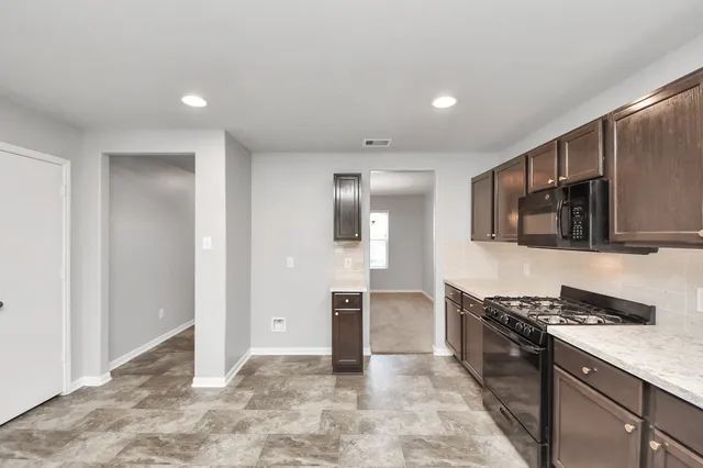 a view of an empty room with a ceiling fan