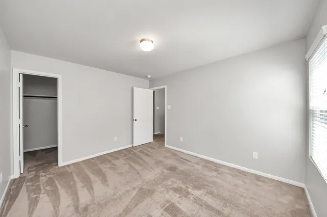 a view of a chair and table in backyard of the house