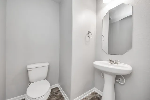 a kitchen with stainless steel appliances kitchen island granite countertop a sink and a stove top oven with wooden floor