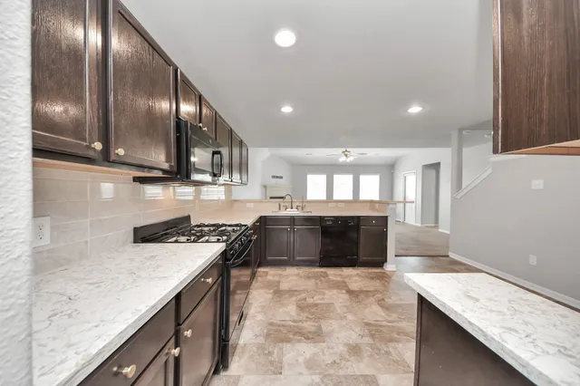 a kitchen with stainless steel appliances granite countertop a stove and a sink