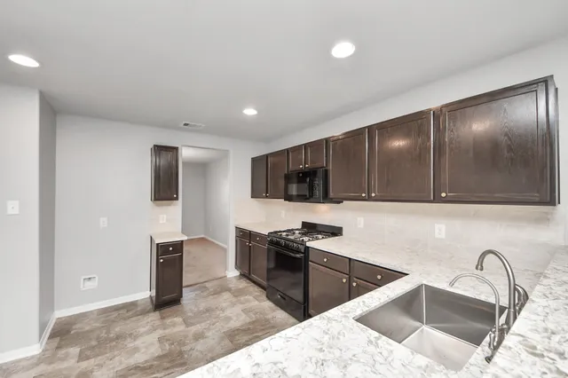 a view of a livingroom with an empty space and a fireplace