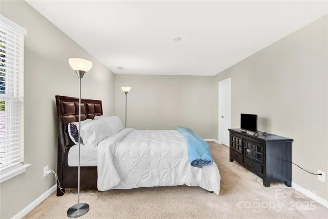a bedroom with a bed and a television