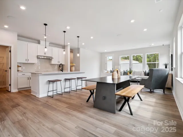 a living room with kitchen island furniture and a wooden floor