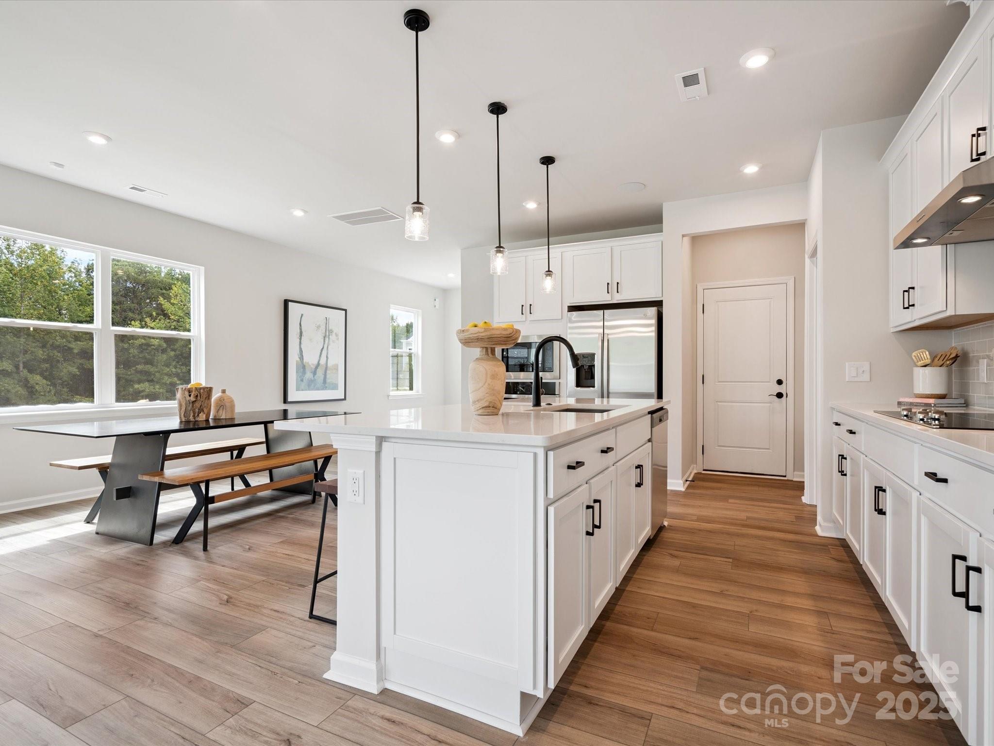 619 Webster Lane Cramerton, NC 28032 - Photo 7 of 20 a open kitchen with white cabinets and wooden floors