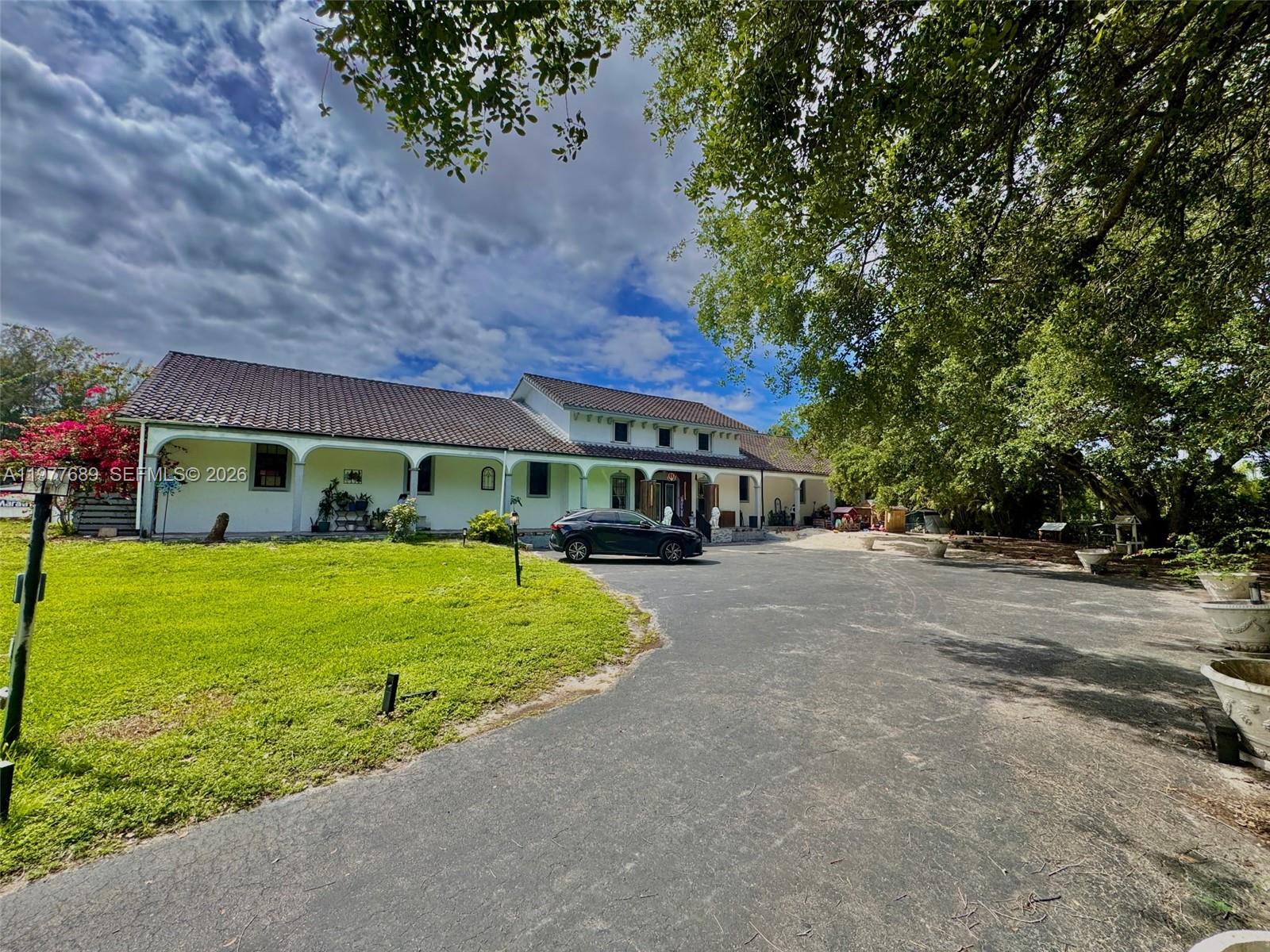 a front view of a house with a garden
