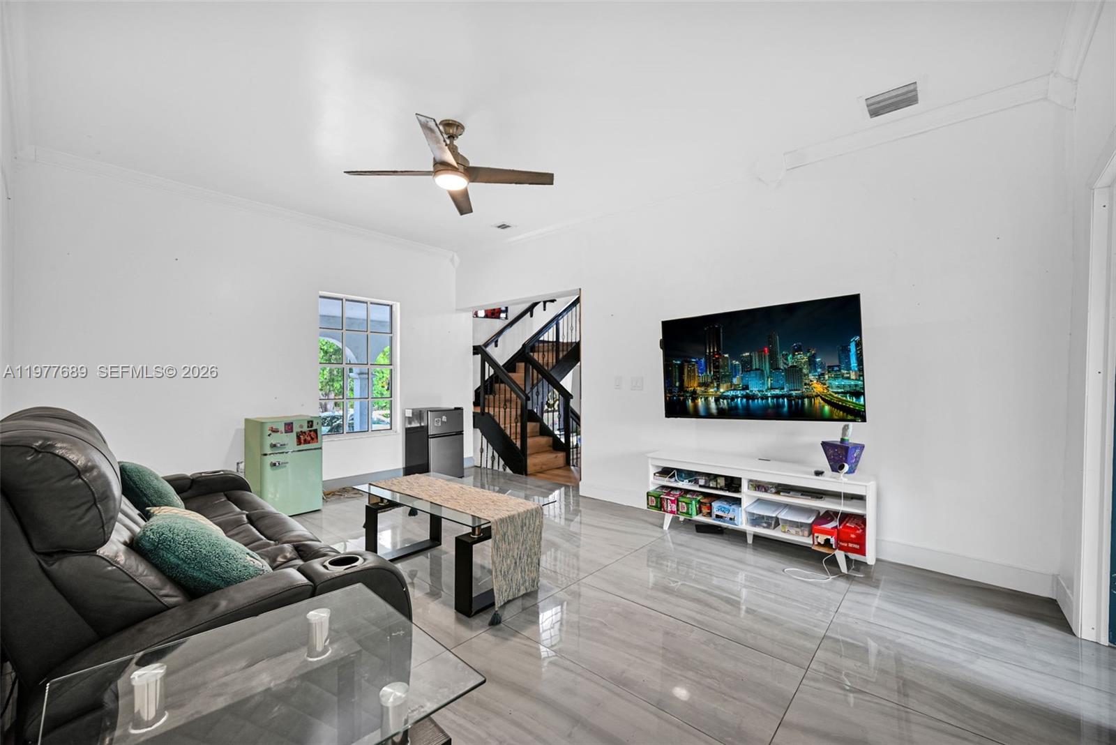 18950 Southwest 50th Street Southwest Ranches, FL 33332 - Photo 25 of 63 a living room with furniture and a flat screen tv