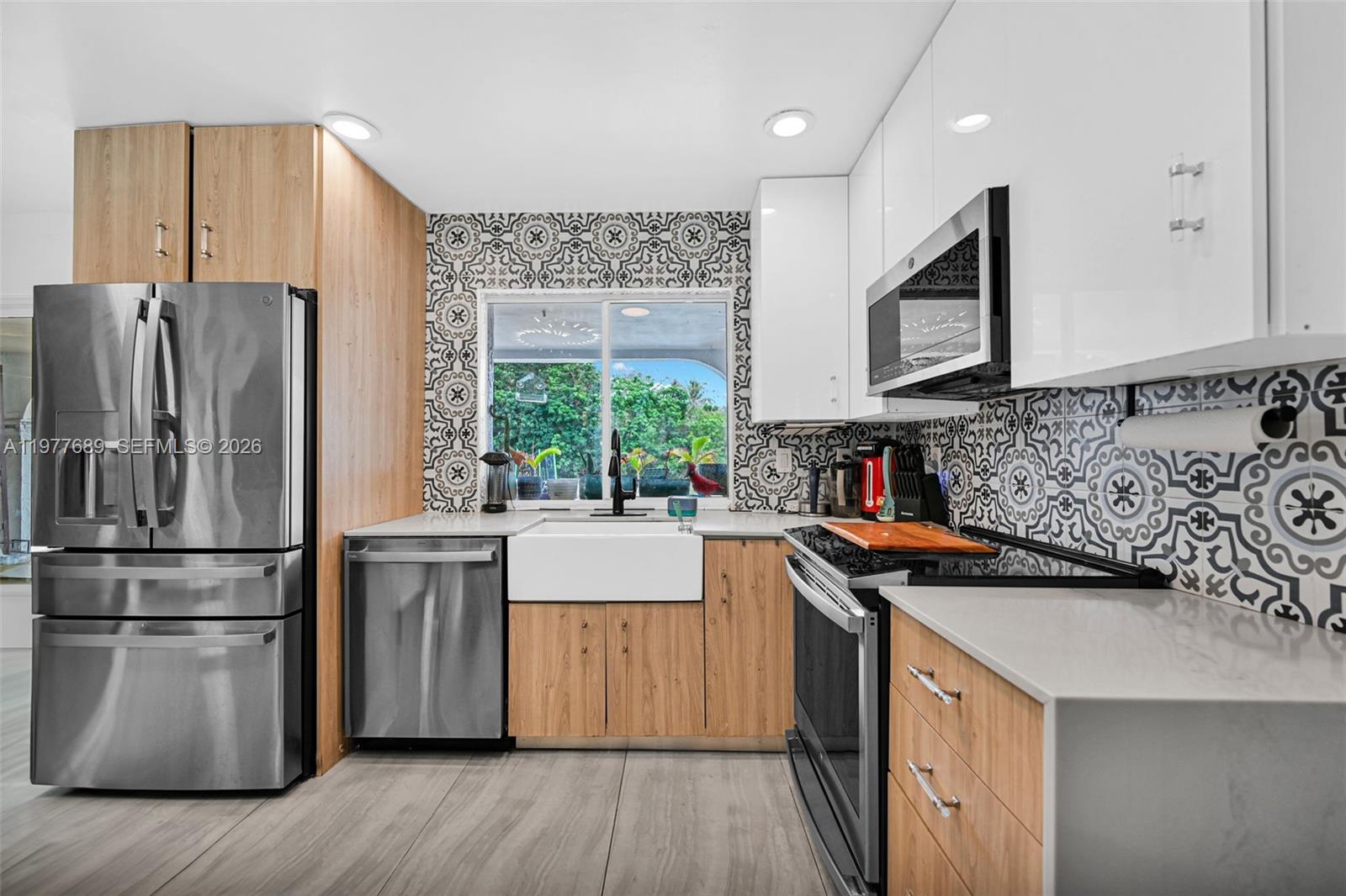 18950 Southwest 50th Street Southwest Ranches, FL 33332 - Photo 8 of 63 a kitchen with stainless steel appliances granite countertop a refrigerator a stove a sink and a microwave