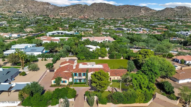 an aerial view of a house with yard swimming pool and outdoor seating