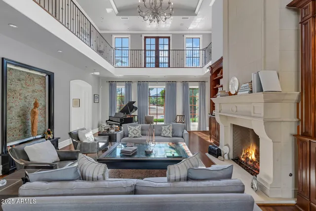 a living room with furniture a fireplace and a large window