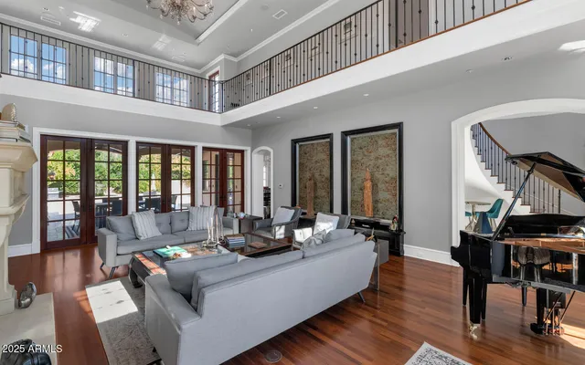 a living room with furniture and large windows