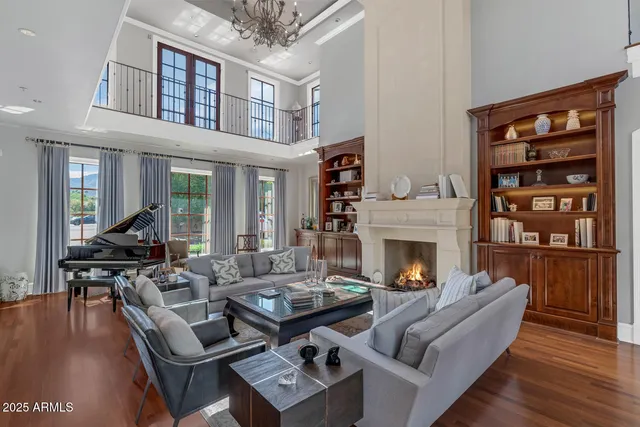 a living room with furniture a fireplace and a table
