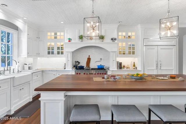a view of a dining room with furniture a chandelier and wooden floor