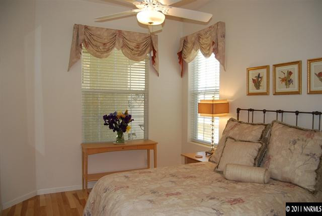 4965 Gila Bend Road Reno, NV 89511 - Photo 9 of 13 a bedroom with a bed and a chandelier