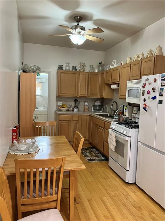 55 4th Avenue Brooklyn, NY 11217 - Photo 5 of 33 a kitchen with stainless steel appliances kitchen island granite countertop a stove a sink dishwasher and a refrigerator with wooden floor