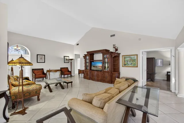 a view of a dining room with furniture and a potted plant