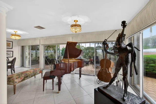 a living room with furniture a piano and a table