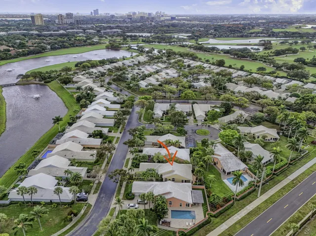 an aerial view of residential houses with outdoor space and river