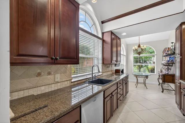 a kitchen with a stove a microwave and wooden cabinets