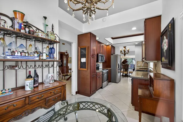 a kitchen with stainless steel appliances granite countertop a refrigerator microwave and sink