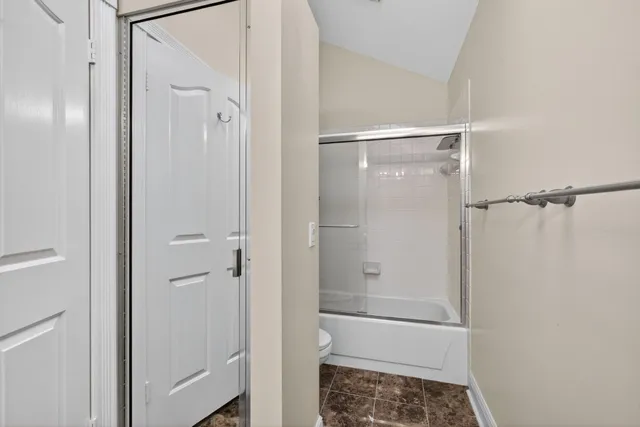 a view of walk in closet with clothes