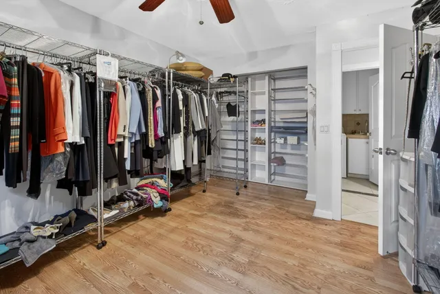 a view of a patio with table and chairs potted plants with wooden floor and fence