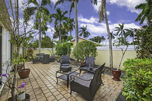 an aerial view of a residential houses with outdoor space and a lake view
