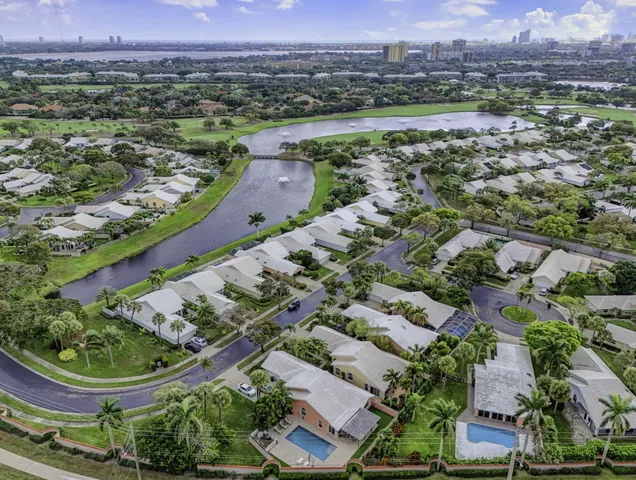 an aerial view of a house with a yard and lake view