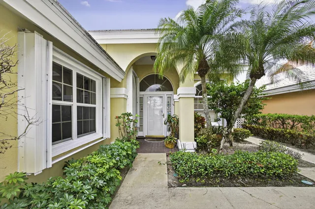 a front view of a house with a garden