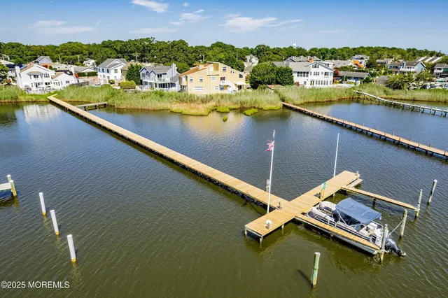 an aerial view of a house with outdoor space and lake view