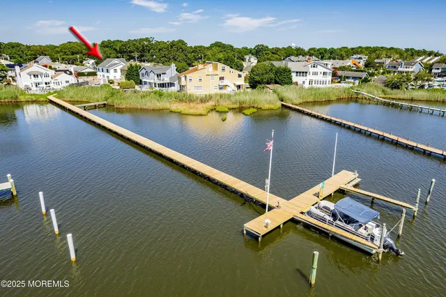 an aerial view of a house with a lake view