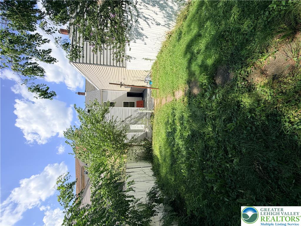 718 Ferry Street Easton, PA 18042 - Photo 28 of 37 A fenced backyard with vibrant green grass offers a private outdoor retreat.