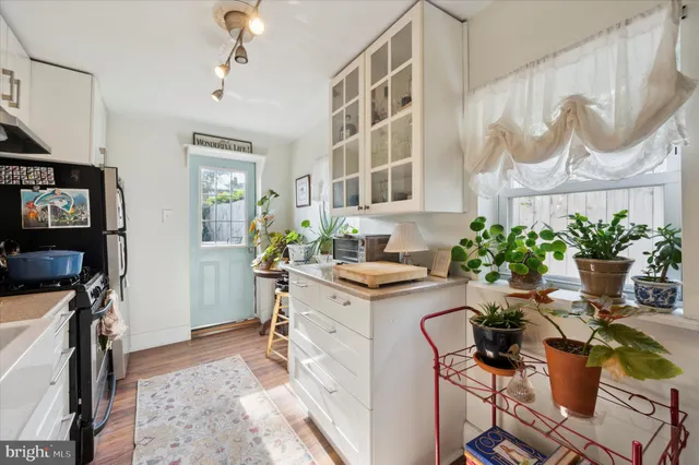 a view of a dining room with furniture a rug and wooden floor