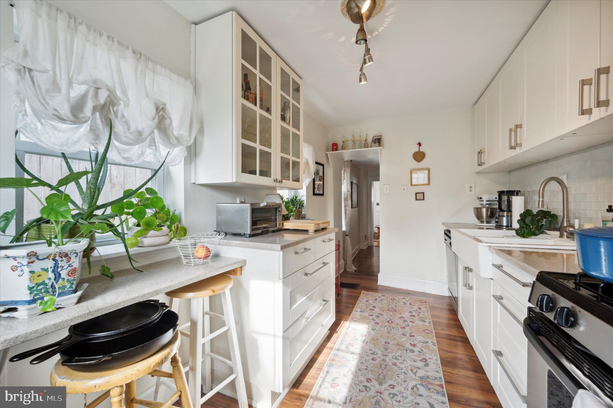 1125 East Moyamensing Avenue Philadelphia, PA 19147 - Photo 14 of 25 a kitchen with stainless steel appliances a stove a cabinets and wooden floor