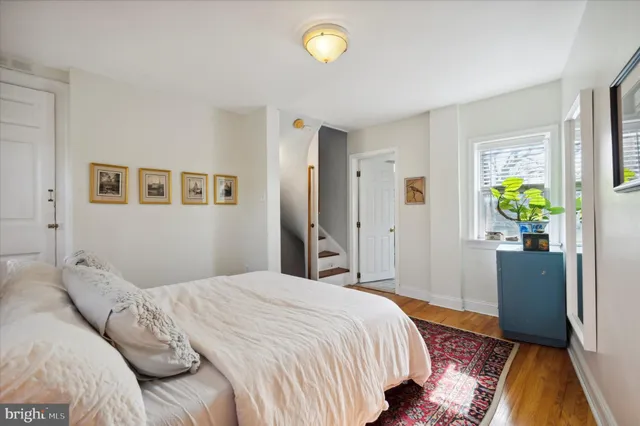 a bedroom with a bed and hallway