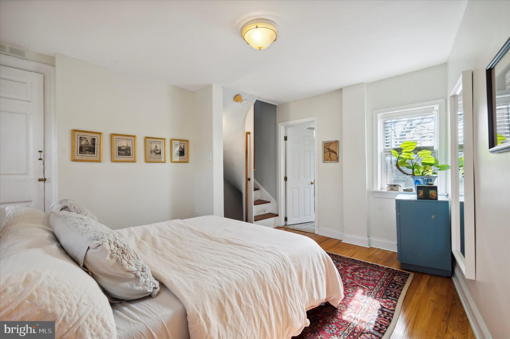 1125 East Moyamensing Avenue Philadelphia, PA 19147 - Photo 16 of 25 a bedroom with a bed and hallway