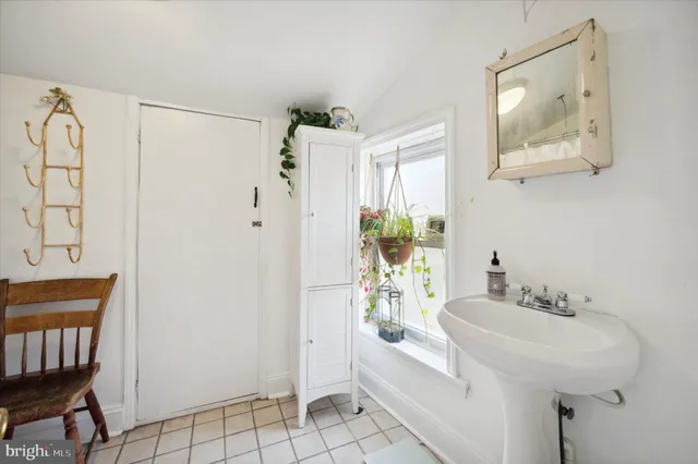 a bathroom with a sink a mirror and a shower