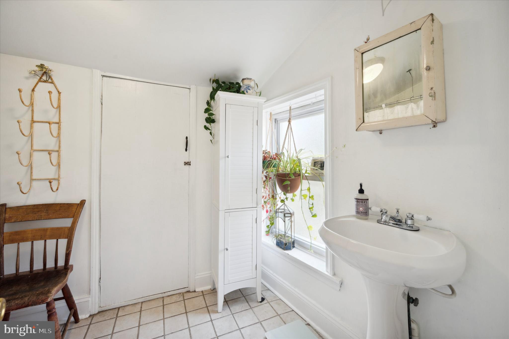 1125 East Moyamensing Avenue Philadelphia, PA 19147 - Photo 18 of 25 a bathroom with a sink a mirror and a shower