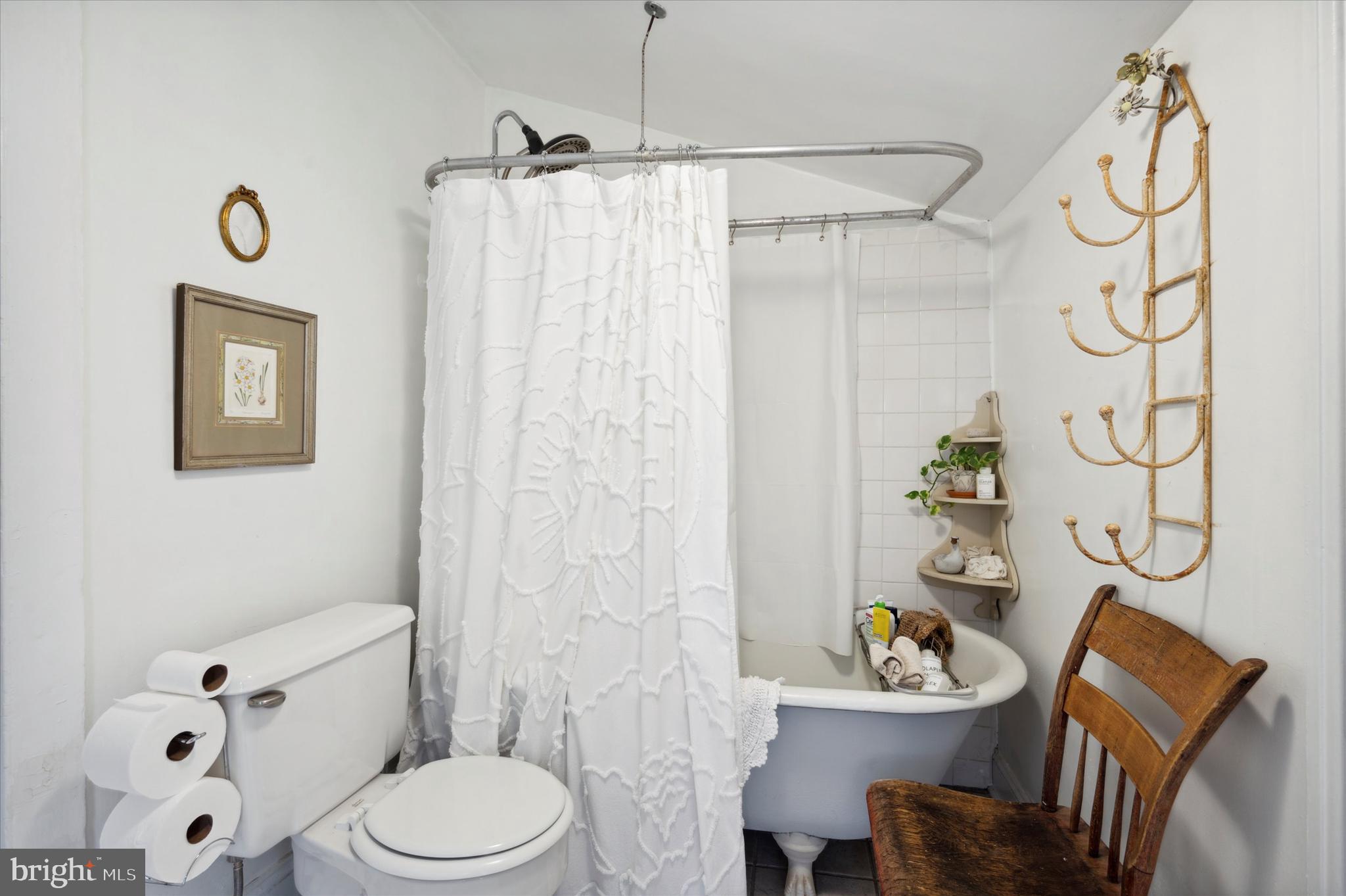 1125 East Moyamensing Avenue Philadelphia, PA 19147 - Photo 19 of 25 a white toilet sitting next to a bathroom sink and a shower