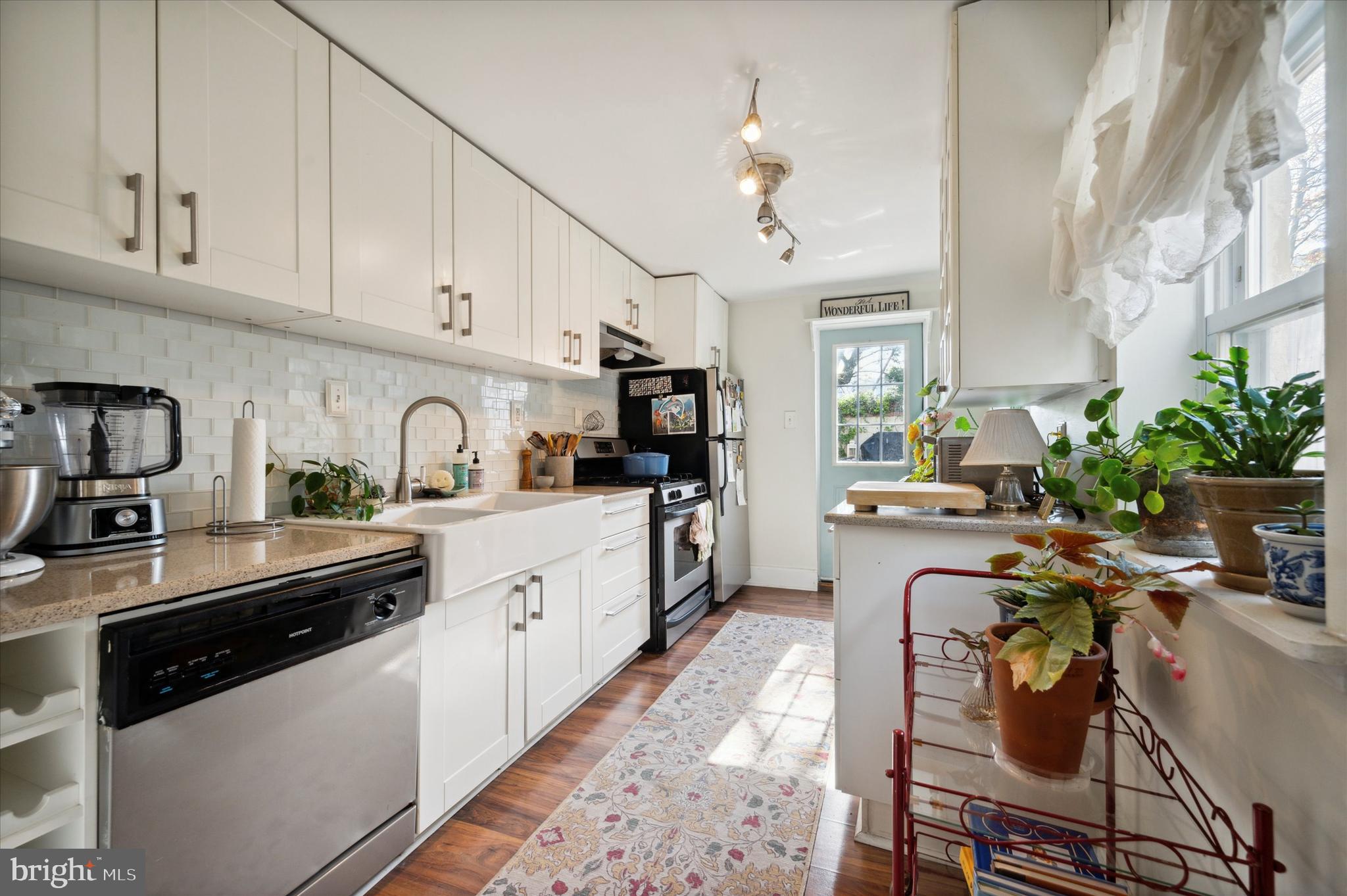 1125 East Moyamensing Avenue Philadelphia, PA 19147 - Photo 24 of 25 a kitchen with granite countertop a sink a stove and cabinets