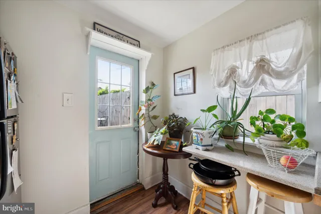 a table with a potted plant and a window