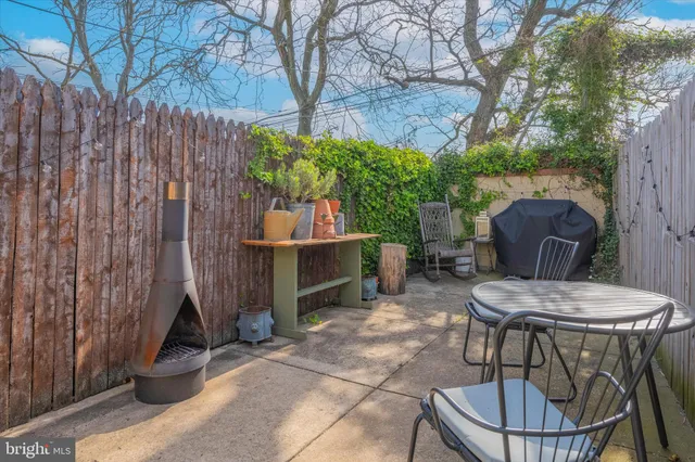 a view of a chairs and table in backyard