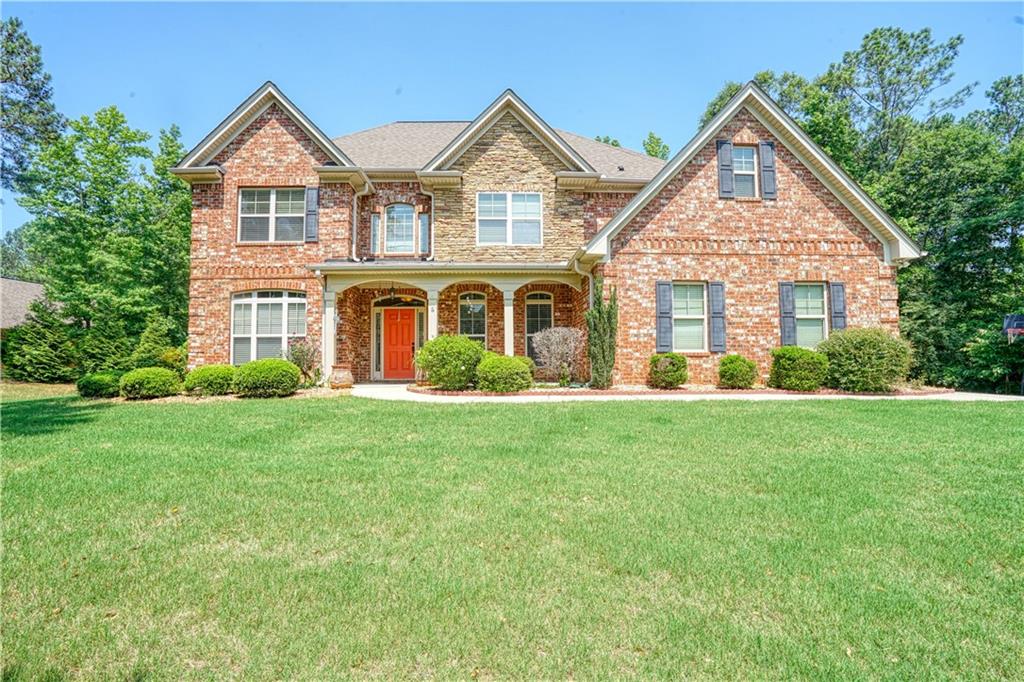 88 Ranan Lane Newnan, GA 30263 - Photo 1 of 1 a front view of a house with a yard and green space