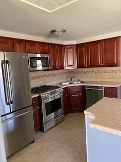 8732 South Corcoran Road, Unit 8732 Hometown, IL 60456 - Photo 5 of 22 a kitchen with granite countertop a stove top oven and cabinets