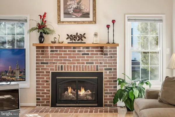 a living room with furniture a fireplace and a table